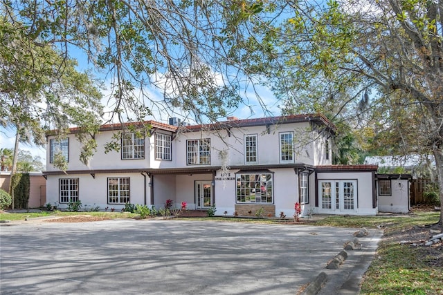 view of front facade featuring french doors and stucco siding