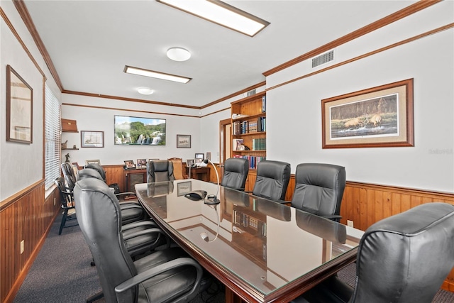 carpeted home office featuring ornamental molding, visible vents, a wainscoted wall, and wooden walls