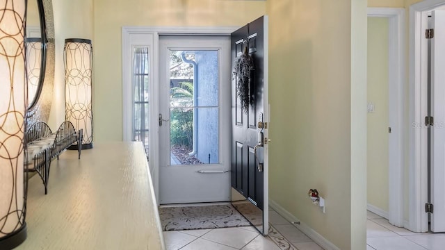 entryway featuring light tile patterned floors and baseboards