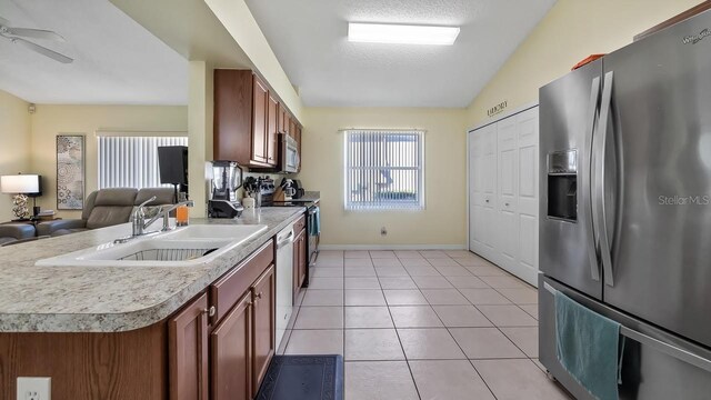 3773 Eversholt St, Clermont, FL 34711 - kitchen featuring a sink, plenty of natural light, stainless steel appliances, light countertops, and light tile patterned floors