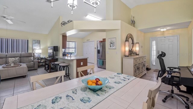 3773 Eversholt St, Clermont, FL 34711 - dining area featuring light tile patterned floors, high vaulted ceiling, and a ceiling fan