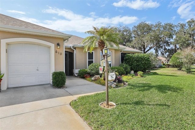 single story home with driveway, an attached garage, a shingled roof, stucco siding, and a front lawn