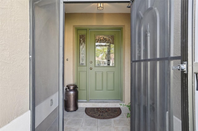 view of exterior entry with stucco siding