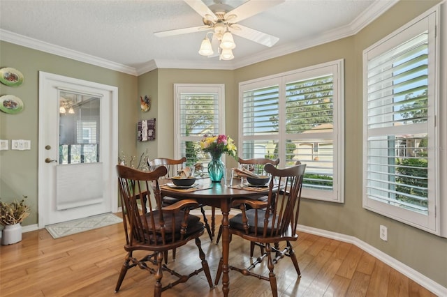 dining space with light wood-style flooring, baseboards, and ceiling fan