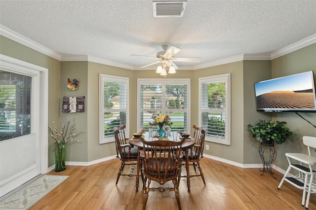 dining area with visible vents, baseboards, a ceiling fan, and light wood finished floors