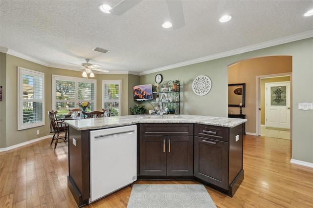 kitchen featuring light wood-type flooring, arched walkways, white dishwasher, dark brown cabinets, and ceiling fan