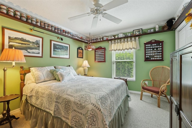 bedroom with ceiling fan, light colored carpet, baseboards, and a textured ceiling