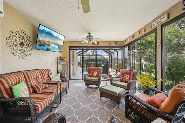 sunroom / solarium featuring a ceiling fan