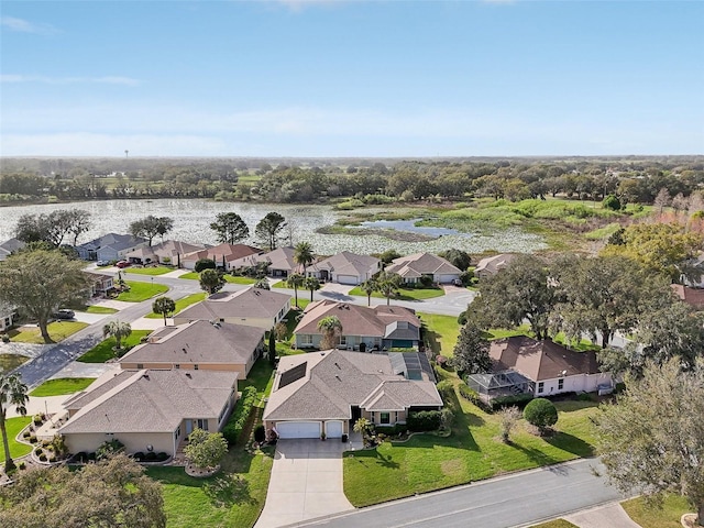 birds eye view of property with a residential view and a water view