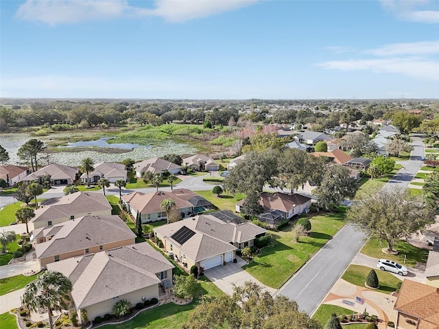 drone / aerial view featuring a residential view and a water view