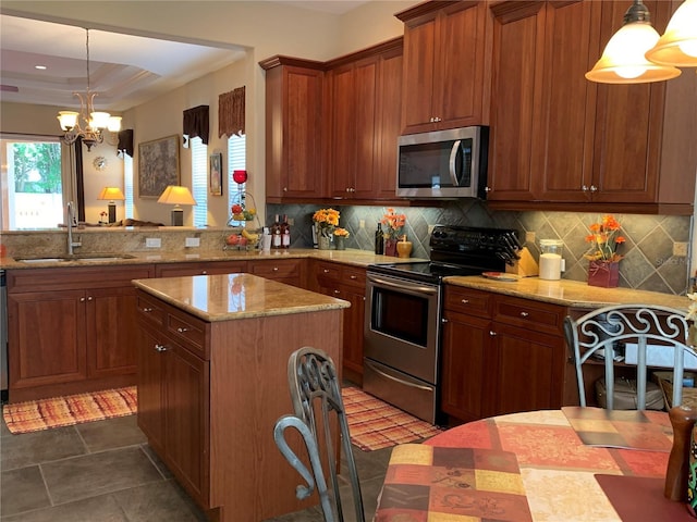 kitchen with decorative backsplash, appliances with stainless steel finishes, light stone countertops, and a sink