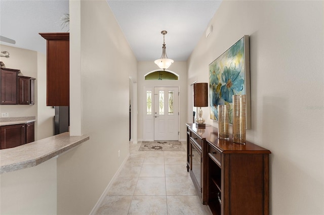 entryway featuring light tile patterned floors and baseboards