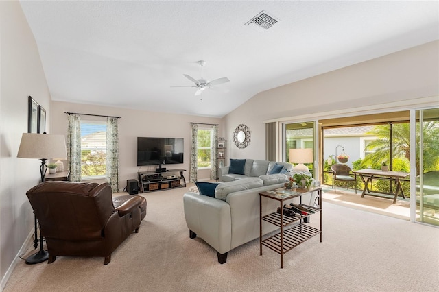 carpeted living room featuring a ceiling fan, a healthy amount of sunlight, visible vents, and vaulted ceiling