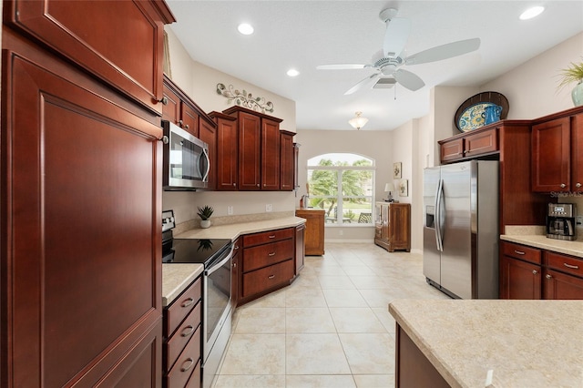 kitchen featuring light countertops, appliances with stainless steel finishes, and dark brown cabinets