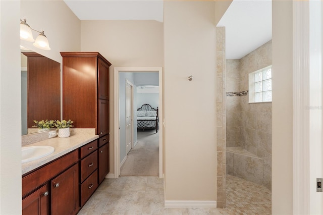 ensuite bathroom with baseboards, ensuite bath, tile patterned floors, walk in shower, and vanity