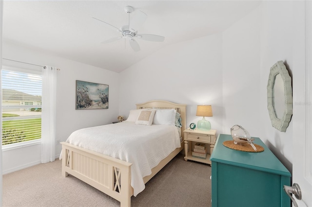 carpeted bedroom with ceiling fan, baseboards, and vaulted ceiling