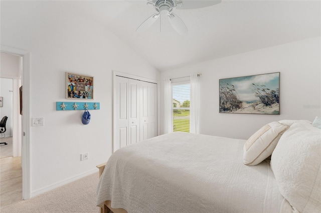 bedroom featuring baseboards, a ceiling fan, carpet, vaulted ceiling, and a closet