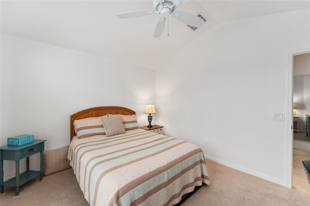 bedroom with light carpet, ceiling fan, vaulted ceiling, and baseboards