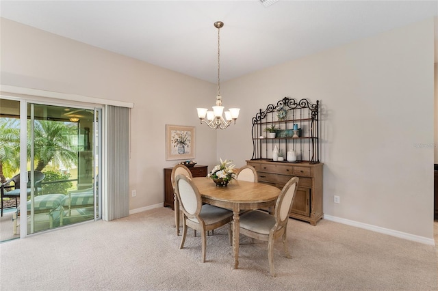 dining area with light carpet, baseboards, and an inviting chandelier