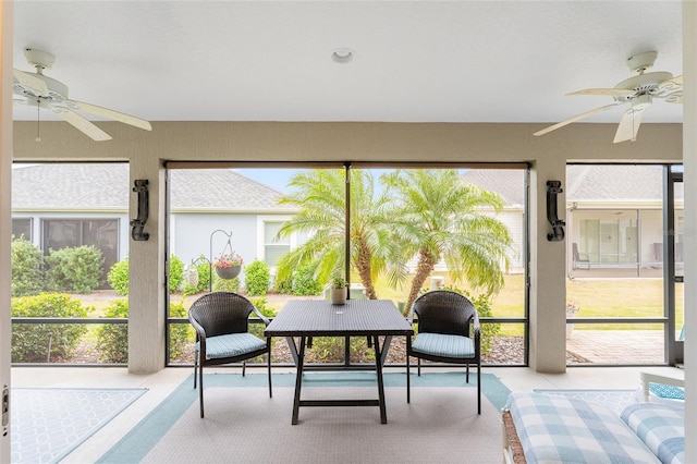 sunroom / solarium featuring a ceiling fan