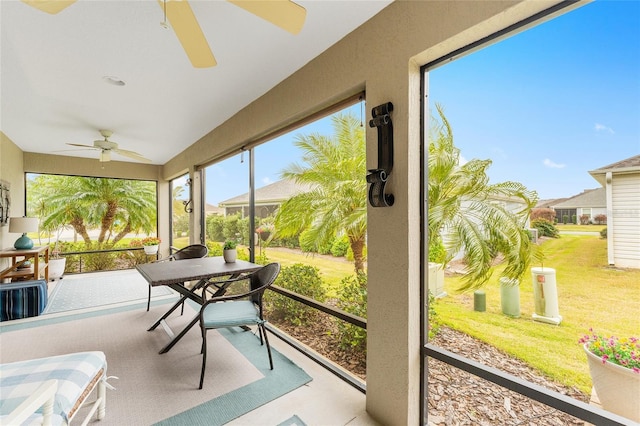 sunroom featuring lofted ceiling and a ceiling fan