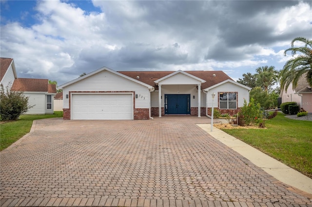 ranch-style home with a garage, a front lawn, decorative driveway, and brick siding