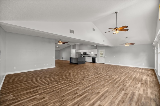 unfurnished living room with high vaulted ceiling, wood finished floors, visible vents, and baseboards