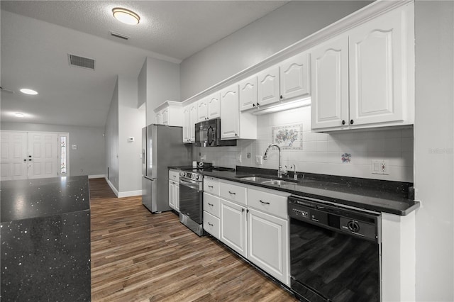 kitchen featuring a sink, visible vents, white cabinetry, black appliances, and dark wood finished floors