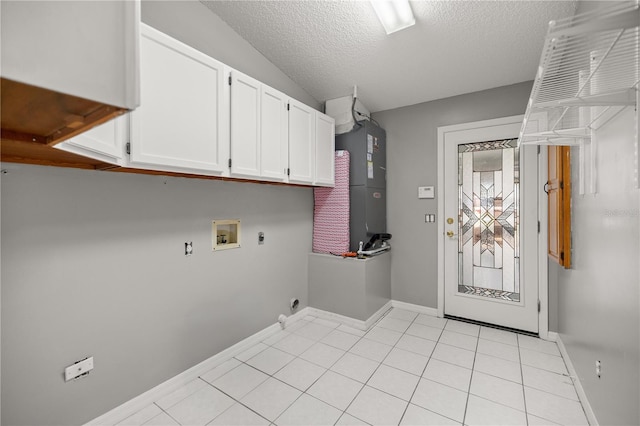 clothes washing area with light tile patterned floors, a textured ceiling, hookup for a washing machine, hookup for an electric dryer, and cabinet space