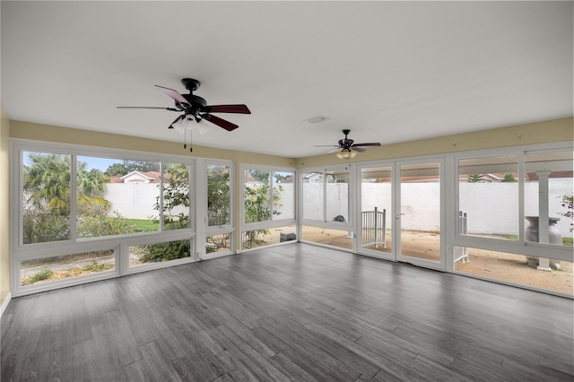 unfurnished sunroom with a ceiling fan