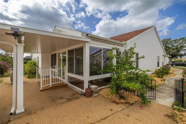 back of house featuring a sunroom