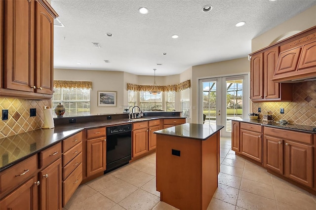 kitchen with black appliances, a kitchen island, dark countertops, and a sink