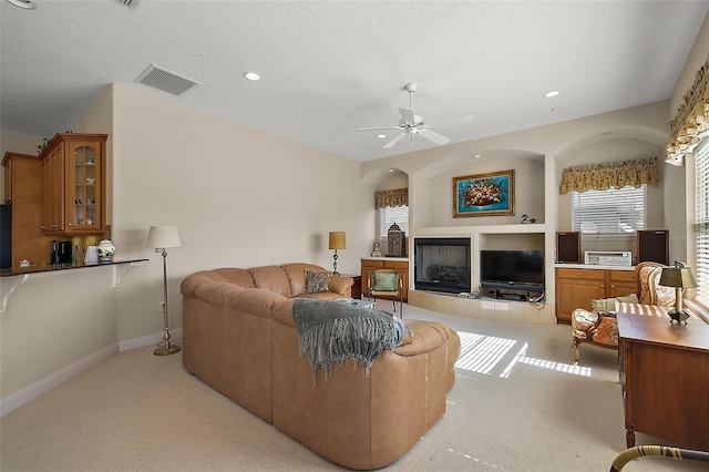 living area featuring light colored carpet, visible vents, and recessed lighting