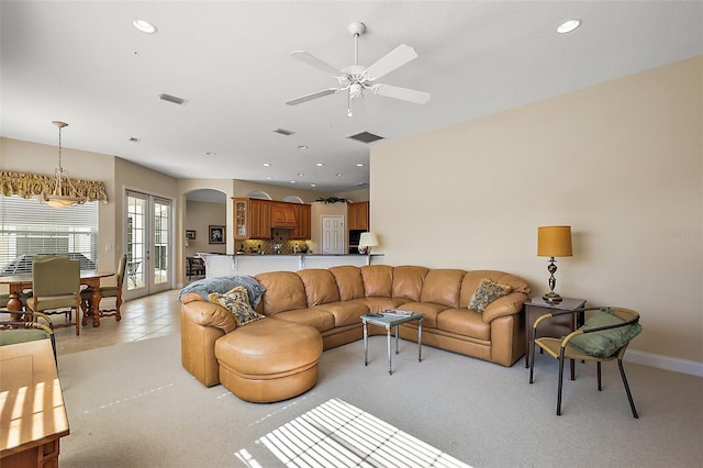 living area with visible vents, arched walkways, french doors, and recessed lighting