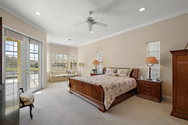 bedroom with light colored carpet, access to exterior, a textured ceiling, french doors, and crown molding