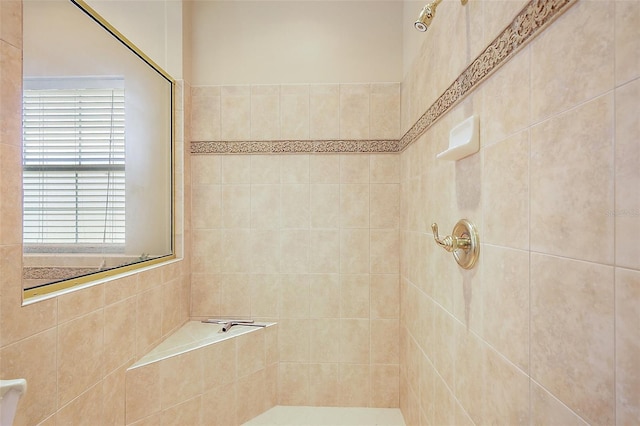 full bath with a tile shower