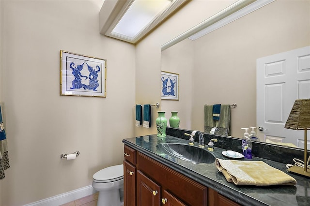 half bath with tile patterned flooring, vanity, toilet, and baseboards