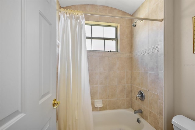 bathroom with toilet and shower / bath combo