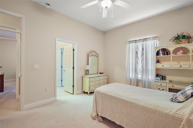 bedroom with ceiling fan, baseboards, and light colored carpet