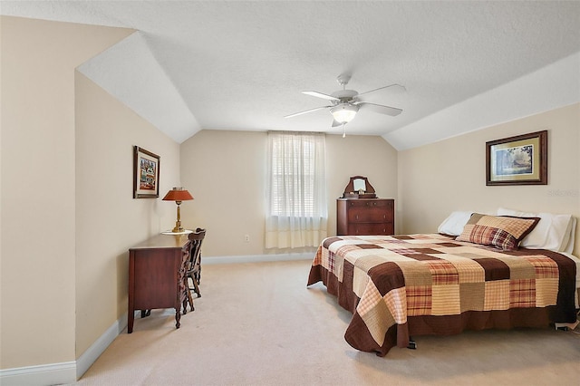 bedroom with vaulted ceiling, a textured ceiling, and baseboards