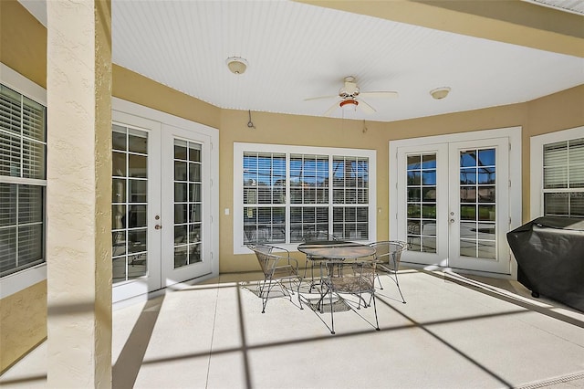 sunroom / solarium with french doors and a ceiling fan