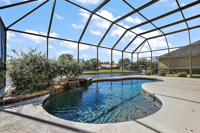 outdoor pool featuring a water view, glass enclosure, and a patio area