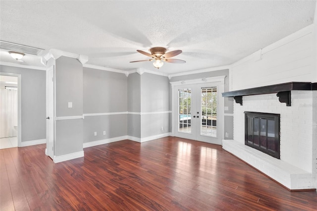 unfurnished living room with french doors, visible vents, a fireplace, and wood finished floors