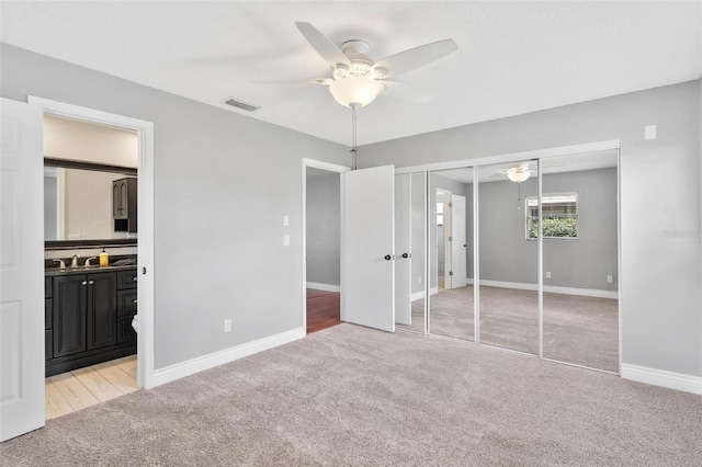 unfurnished bedroom with baseboards, visible vents, and light colored carpet