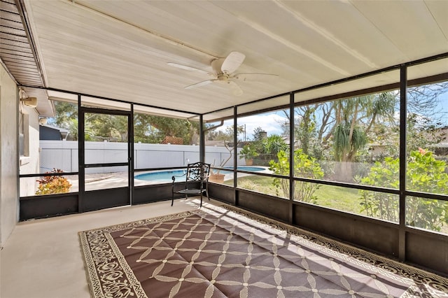 unfurnished sunroom featuring a ceiling fan