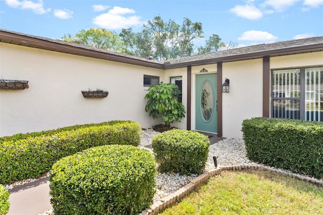 entrance to property with stucco siding