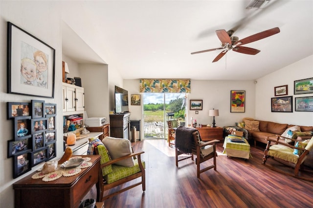 living room with dark wood-style floors, visible vents, vaulted ceiling, and a ceiling fan