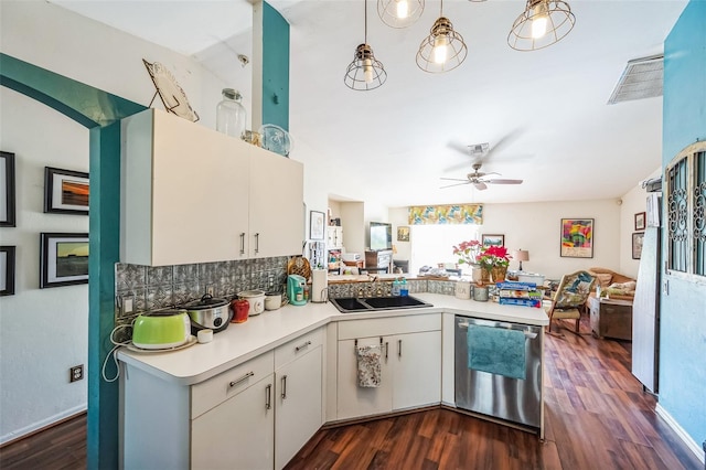 kitchen featuring light countertops, open floor plan, a sink, dishwasher, and a peninsula