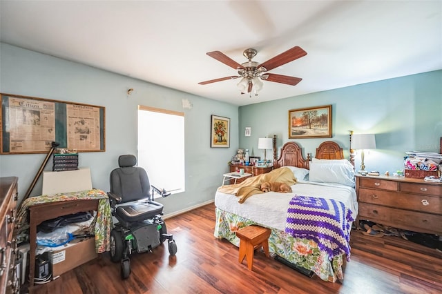 bedroom featuring wood finished floors, a ceiling fan, and baseboards