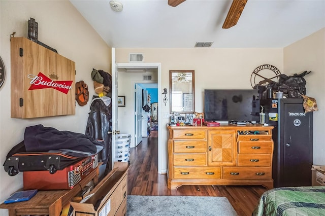 bedroom featuring visible vents, dark wood finished floors, and a ceiling fan